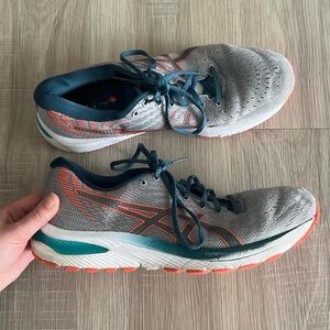 Gray ASICS running trainers with turquoise and orange accents